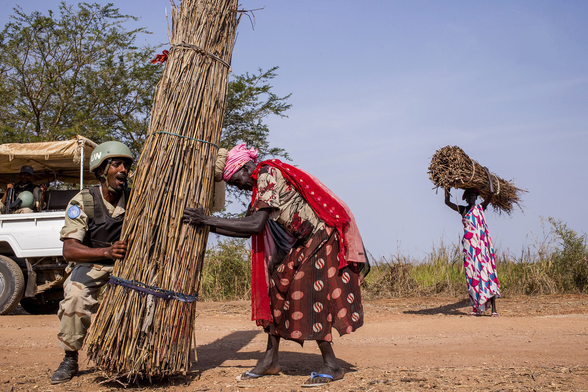 peacekeeper helps woman with her load of firewood peacekeeper helps woman with her load of firewood