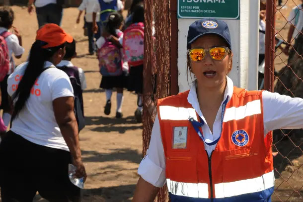 woman in safety vest directing crowd